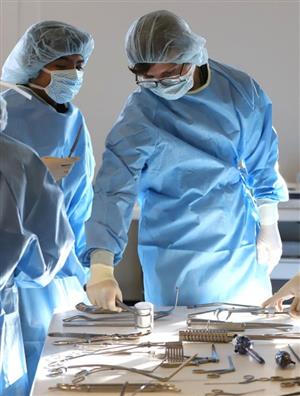 GISH Medical Academy students in scrubs working with medical tools